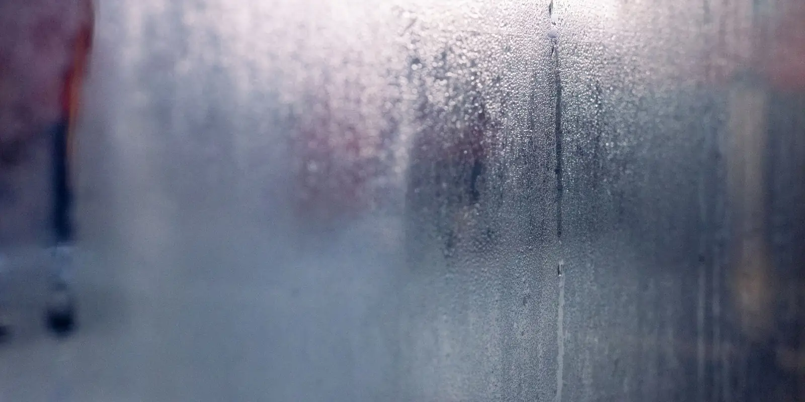 Misted window pane covered in fine condensation droplets
