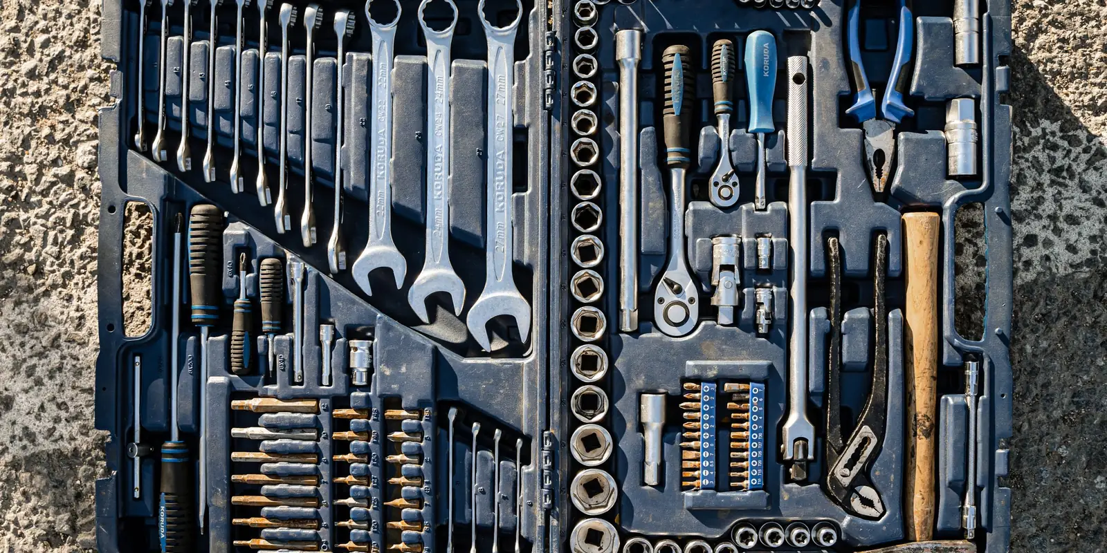 Open tool case with spanners, screwdrivers, pliers and sockets in moulded slots